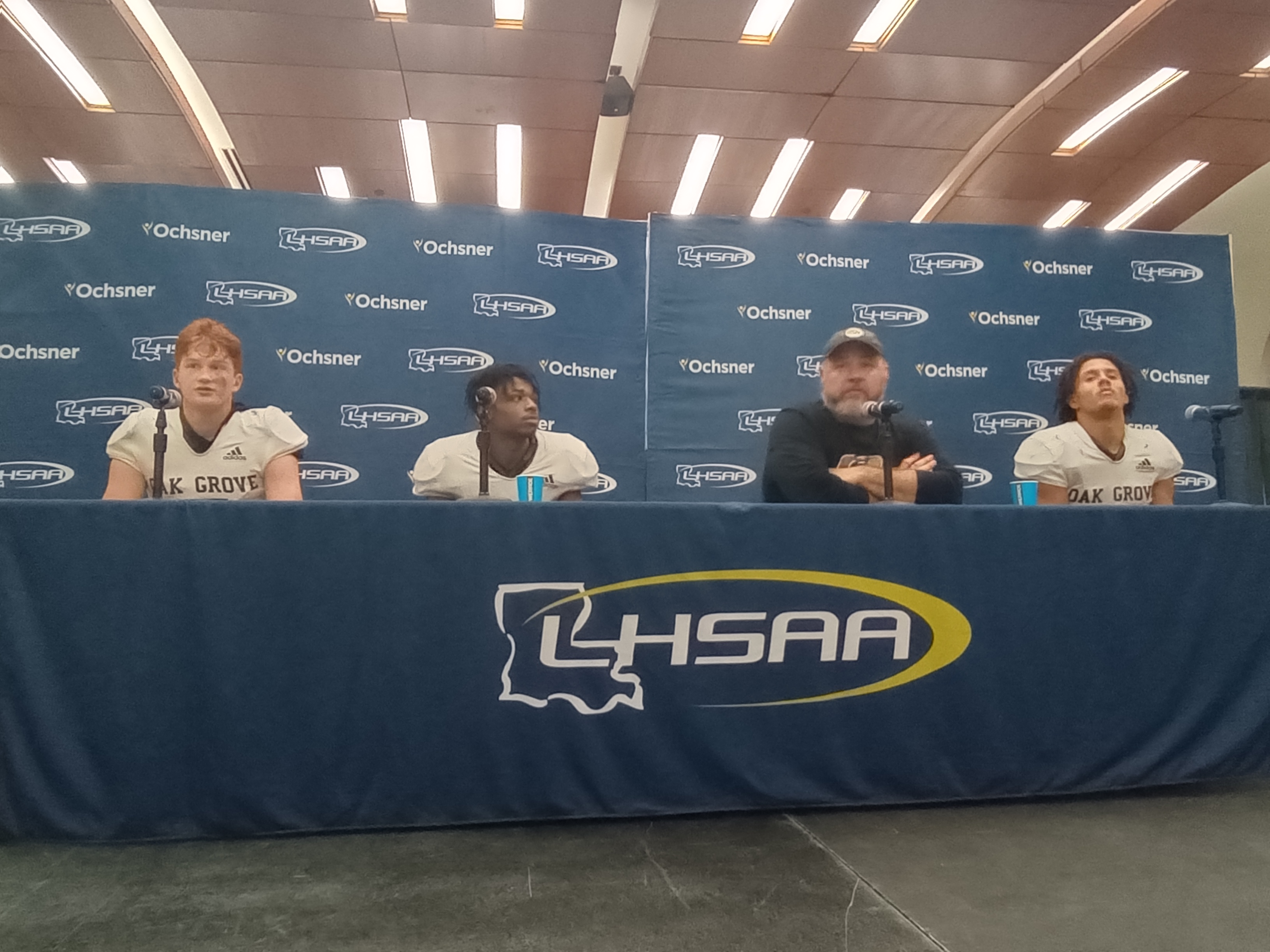 From left, Oak Grove QB Jackson Bradley, TB Decorian Freeman, coach Ryan Gregory and LB Kameron Franklin.
